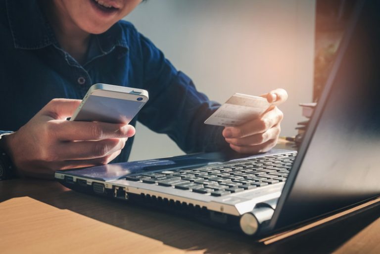 Man Holding Credit Card And Using Laptop shopping online. Online payment concept.