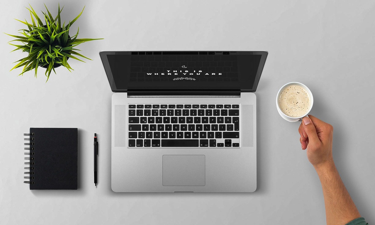 Laptop, coffee, arm — Best forex brokers for your success in trading